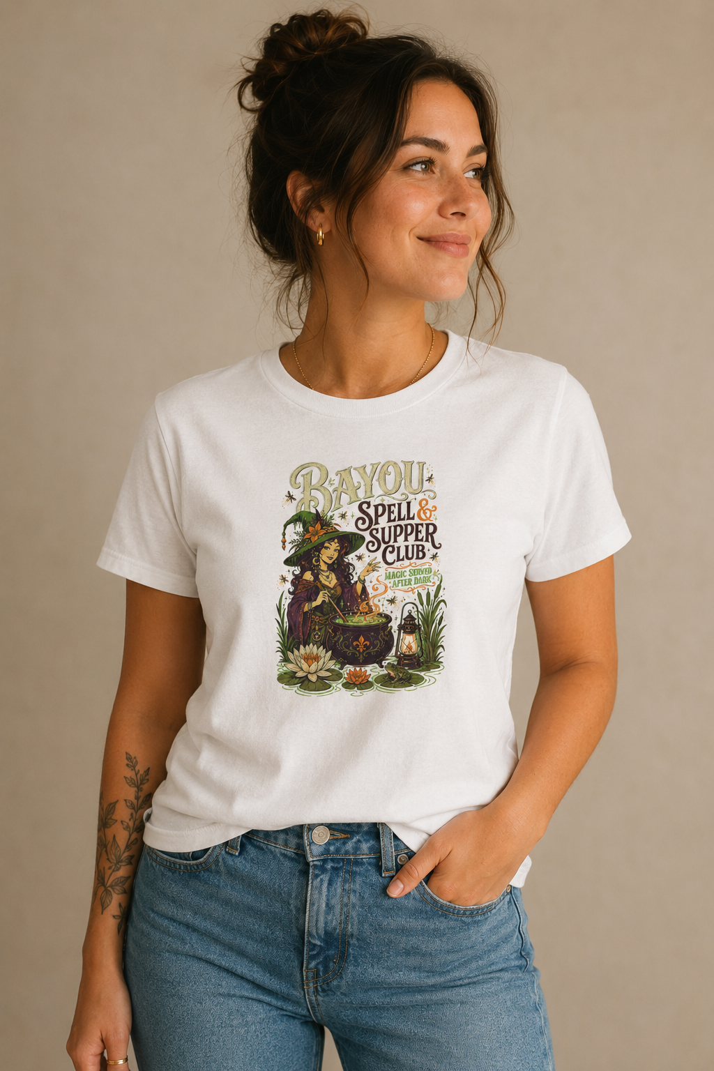 Woman wearing a white Bayou Spell & Supper Club graphic T-shirt