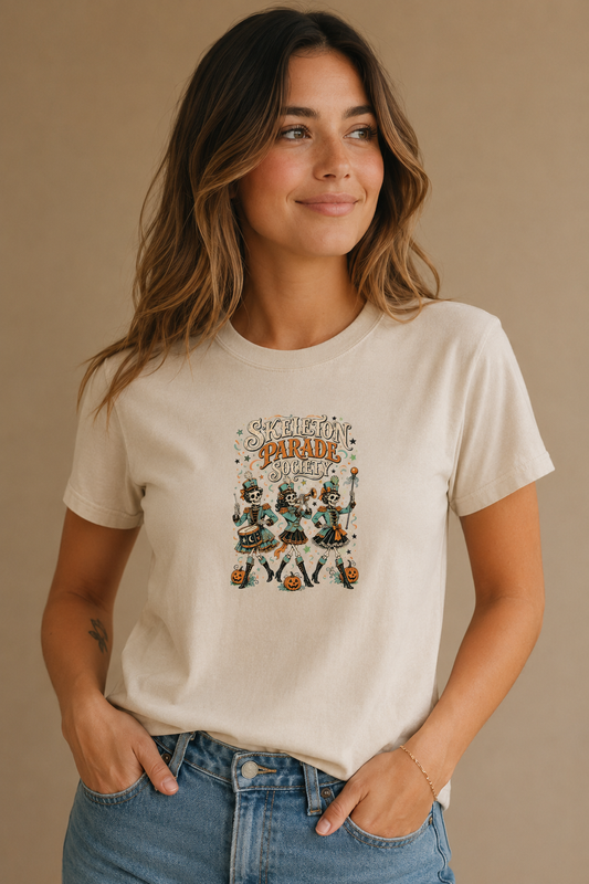 Woman wearing a beige Skeleton Parade Society graphic T-shirt