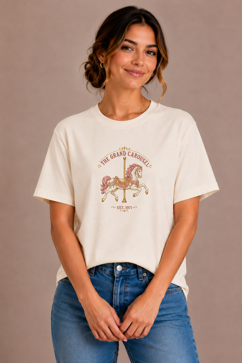 Woman wearing a sand crew-neck t-shirt with The Grand Carousel Est. 1971 carousel horse design printed on the chest