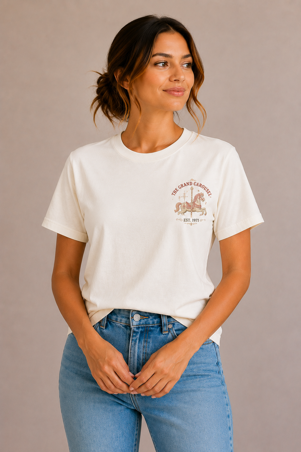 Woman wearing a sand crew-neck t-shirt with the 'The Grand Carousel Est. 1971' carousel horse design printed small on the chest