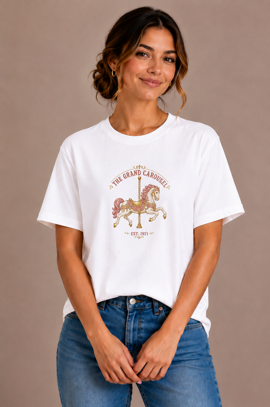 Woman wearing a white crew-neck t-shirt with the 'The Grand Carousel Est. 1971' carousel horse design printed on the chest