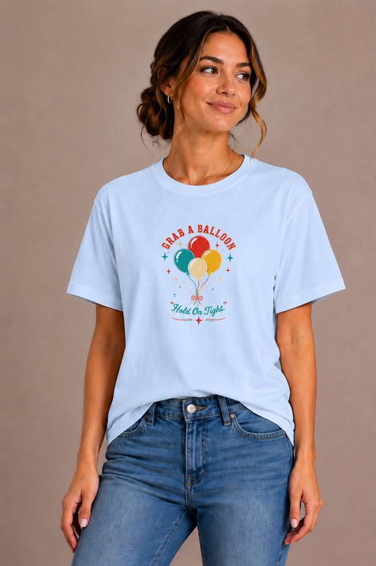 Woman wearing a blue crew-neck t-shirt with the 'Grab a Balloon' retro balloon bunch design printed on the chest