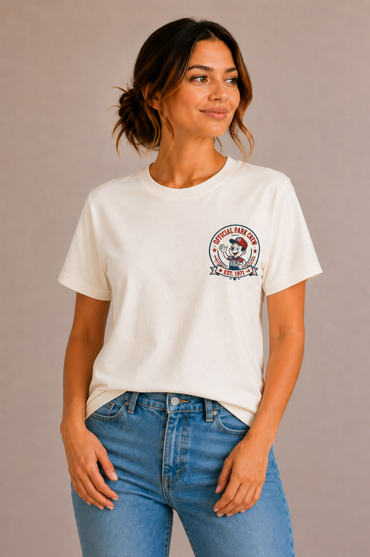 Woman wearing a sand crew-neck t-shirt with the 'Official Park Crew Est. 1971' mascot badge design printed small on the chest