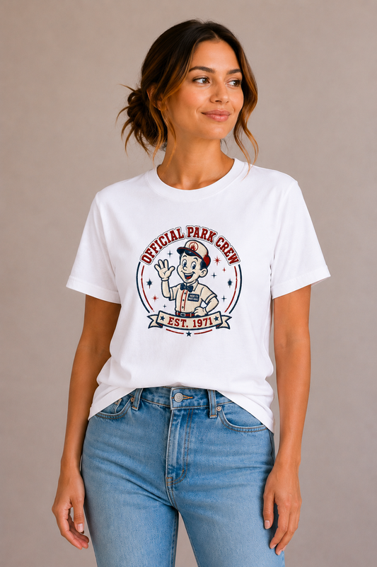 Woman wearing a white crew-neck t-shirt with the 'Official Park Crew Est. 1971' mascot badge design printed on the chest
