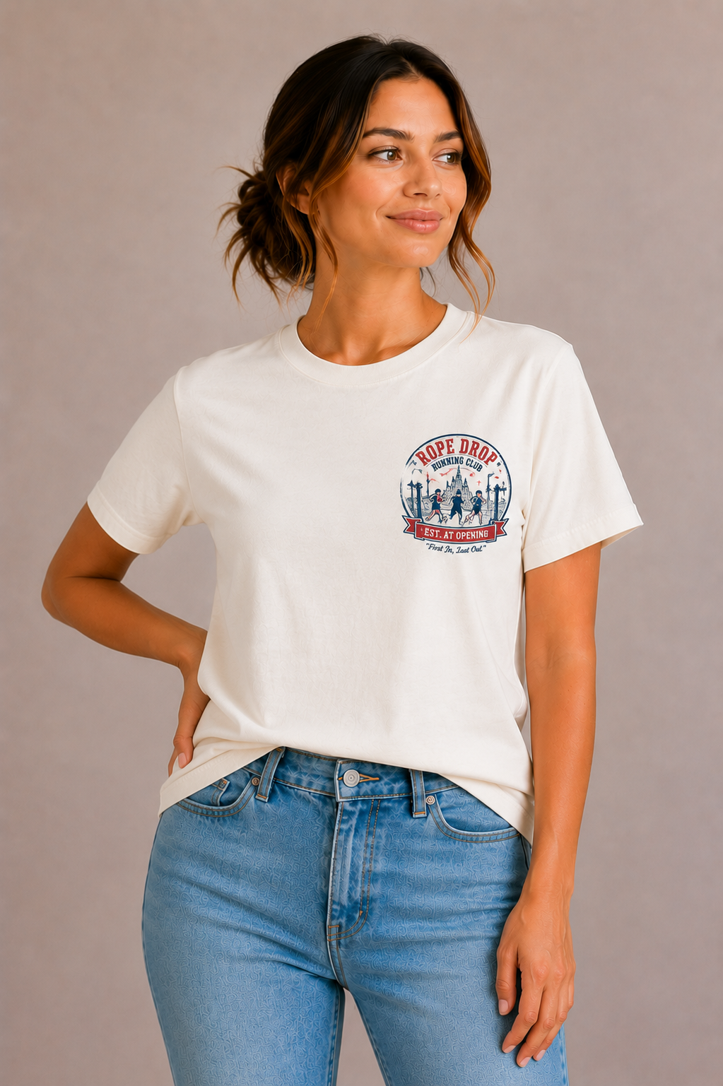 Woman wearing a sand crew-neck t-shirt with the 'Rope Drop Running Club – Est. At Opening' runners badge design printed small on the chest