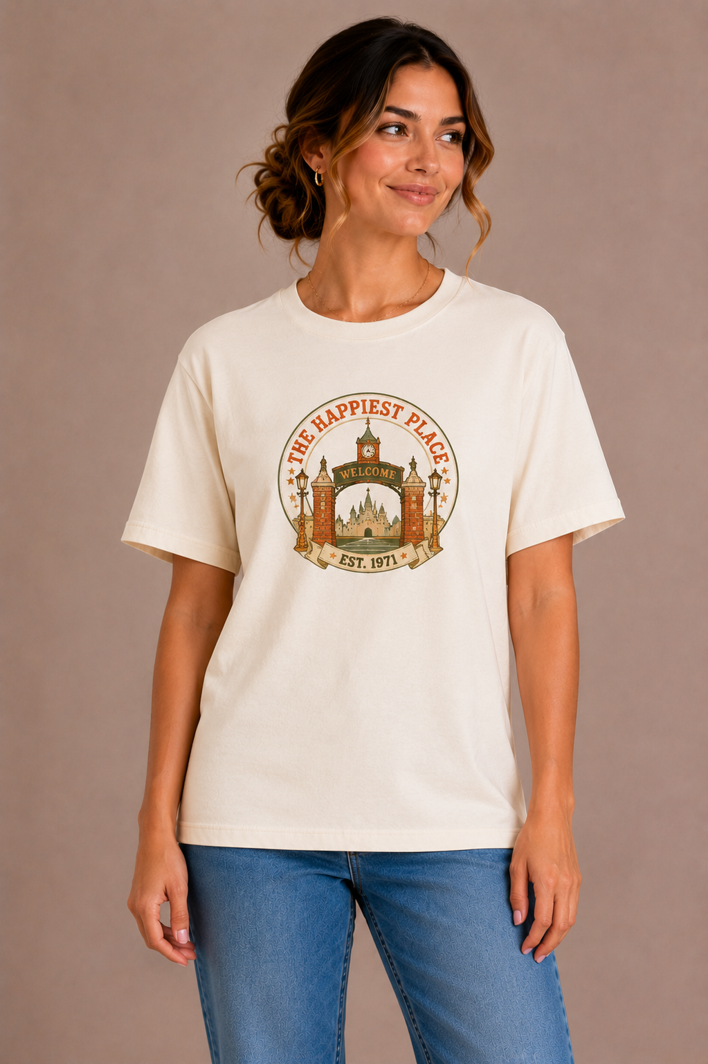 Woman wearing a sand crew-neck t-shirt with the 'The Happiest Place Est. 1971' castle gateway badge design printed on the chest