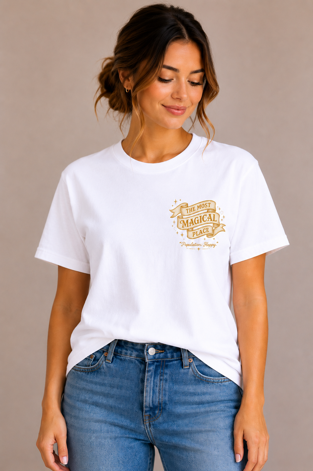 Woman wearing a white crew-neck t-shirt with the 'The Most Magical Place – Population: Happy' ribbon banner design printed on the chest